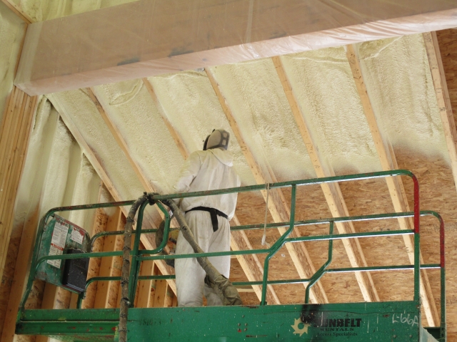 worker spray foam insulating